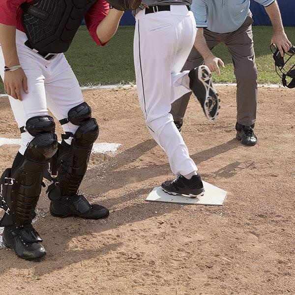 Champion Sports Universal Home Plate with a player stepping on it
