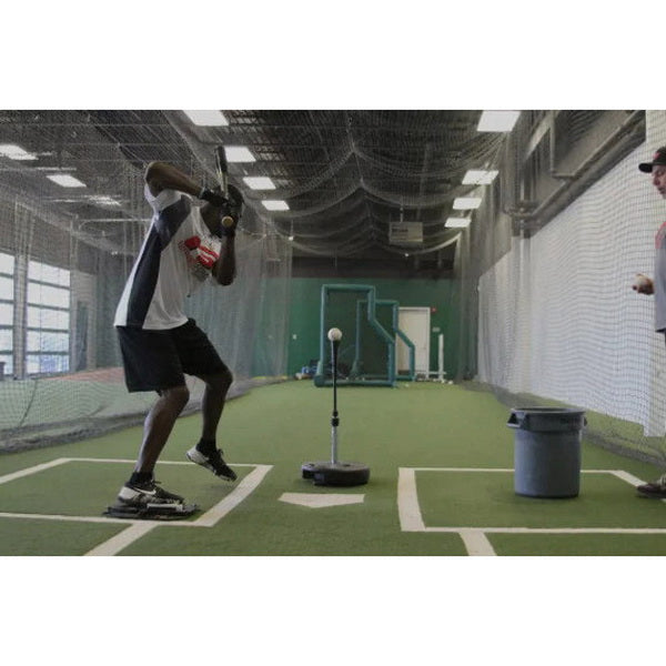 The King Of The Swing Baseball Swing Trainer indoor practice in batting cage