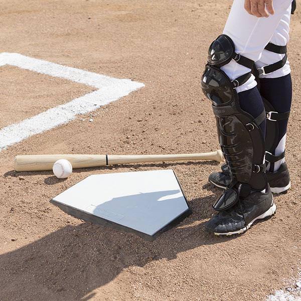 Champion Anchored Home Plate With Bat and Ball Besides a Player