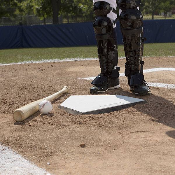 Champion Anchored Home Plate With a Bat and Ball in Front of a Player