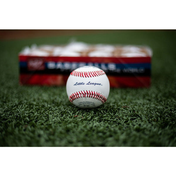 Rawlings Little League Baseballs - Competition Grade In Grass With Box in the Background