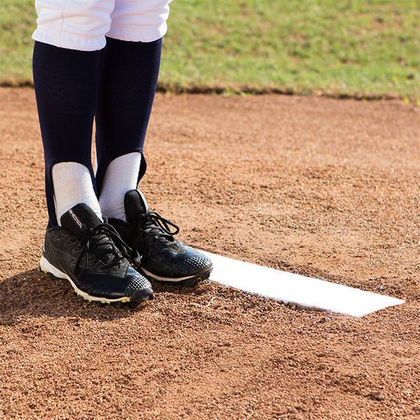 Champion Sports 4 Way Youth Pitcher's Box with a player's legs beside