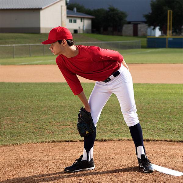 Champion Sports Pro Model 4 Way Pitcher's Plate with a player beside it full body 