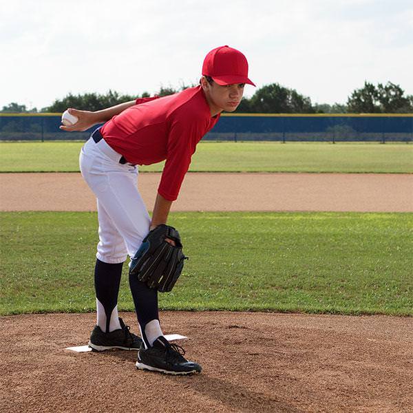 Champion Sports Pro Model 4 Way Pitcher's Plate with a player beside it side view