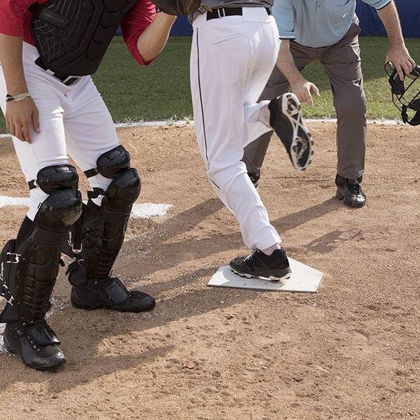 Champion Sports Universal Home Plate with a player stepping on it 