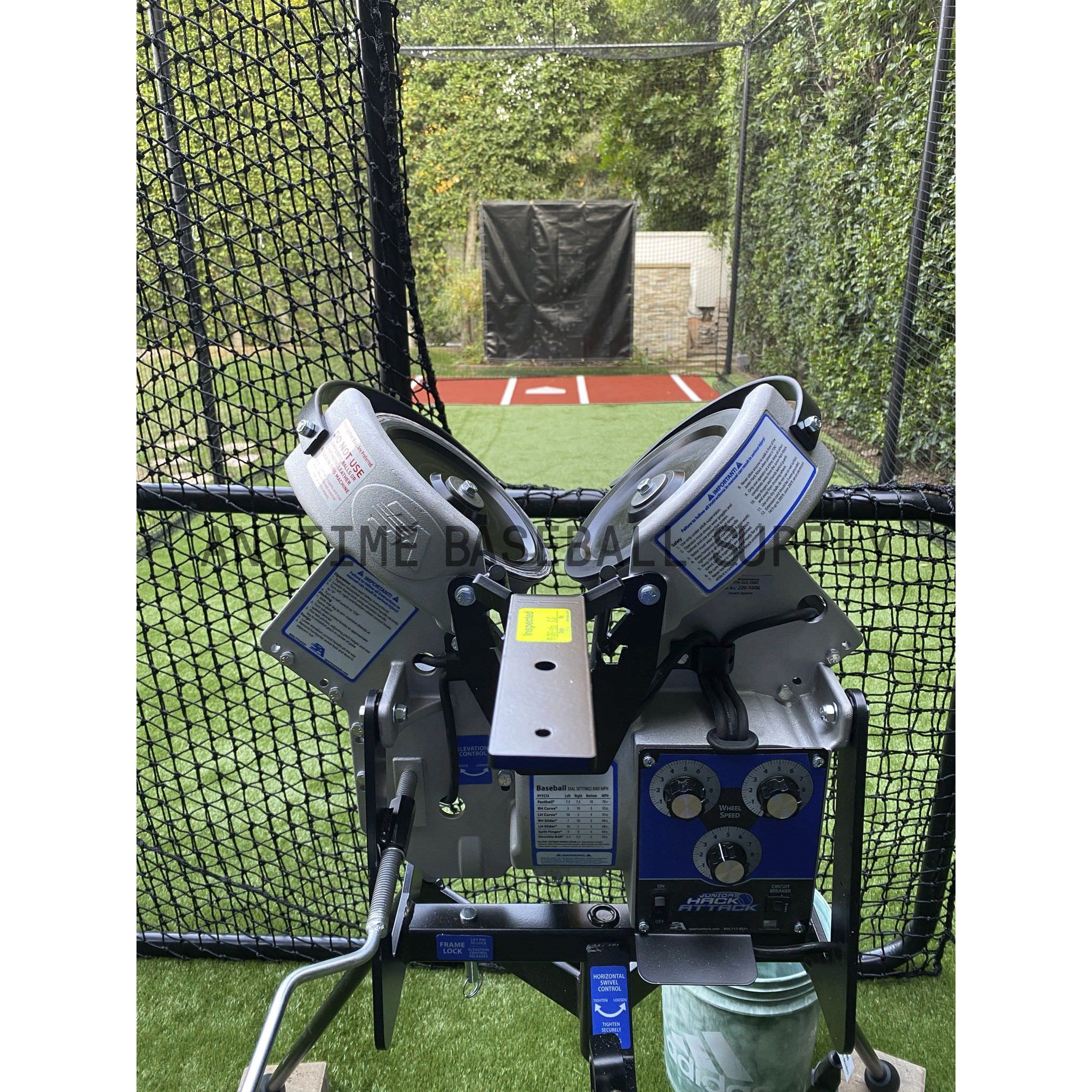 Jr. Hack Attack Three Wheel Pitching Machine rear view inside batting cage