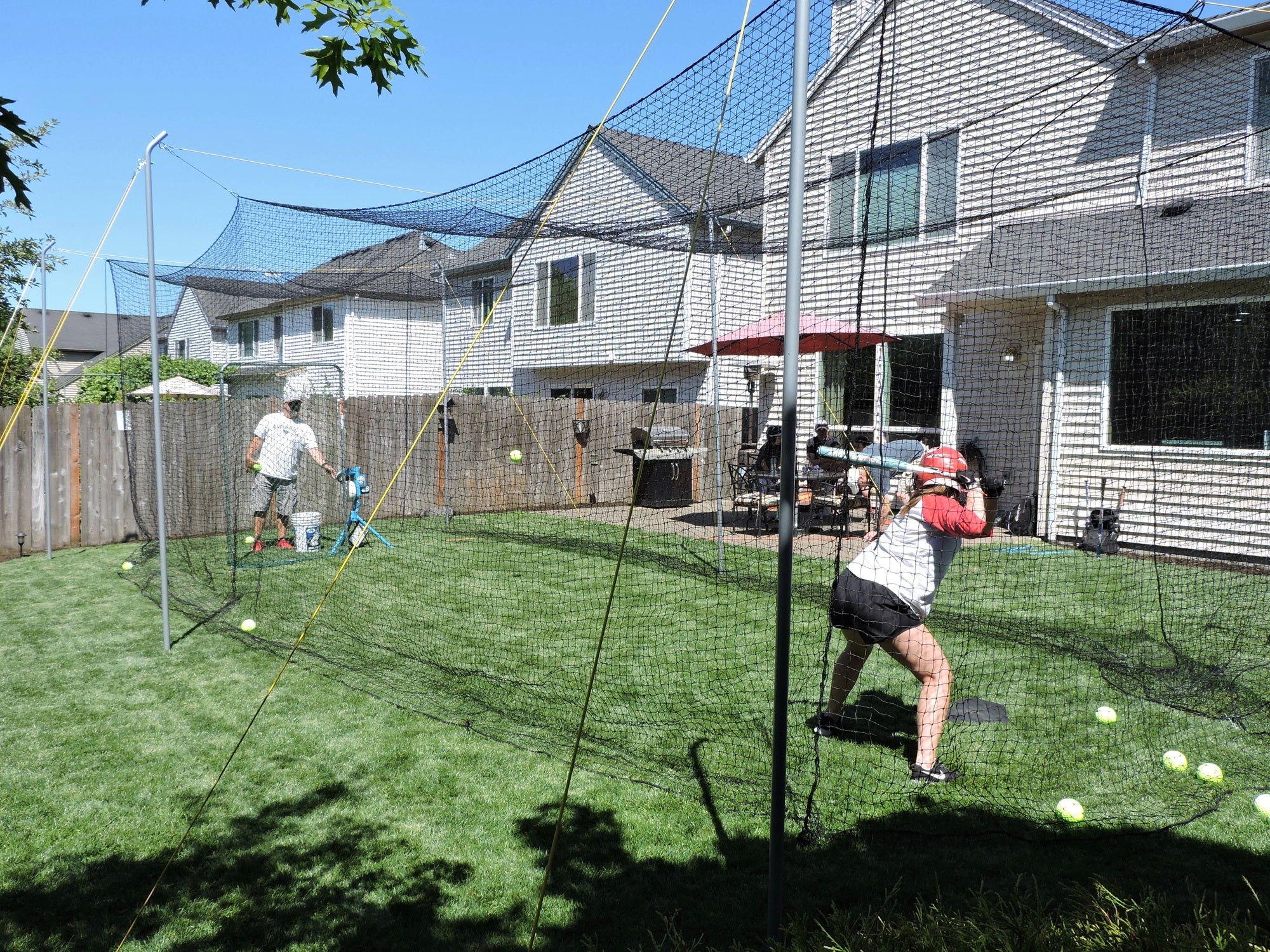 Jugs Hit at Home Complete Backyard Batting Cage with Pitching Machine and Batter in Practice