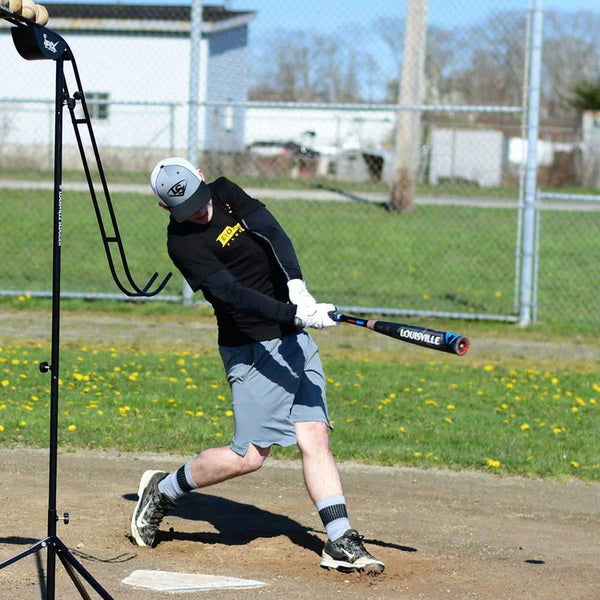 Louisville Slugger Soft-Toss Pitching Machine With Player Batting Practice Side View