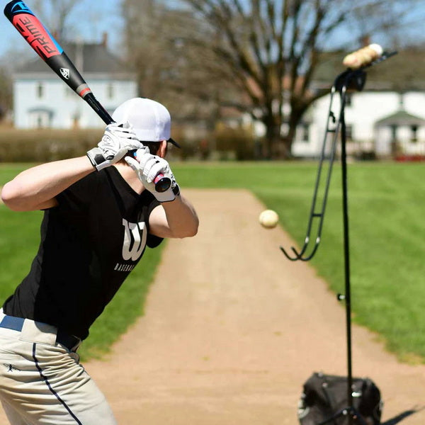 Louisville Slugger Soft-Toss Pitching Machine With Player In Action