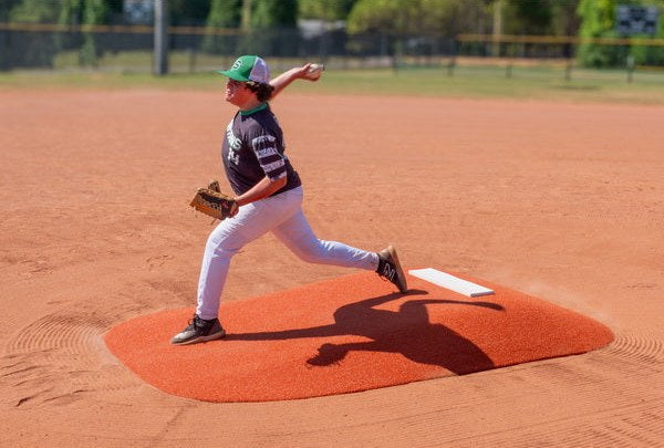 Youth pitcher on a clay Allstar 8 inch portable mound